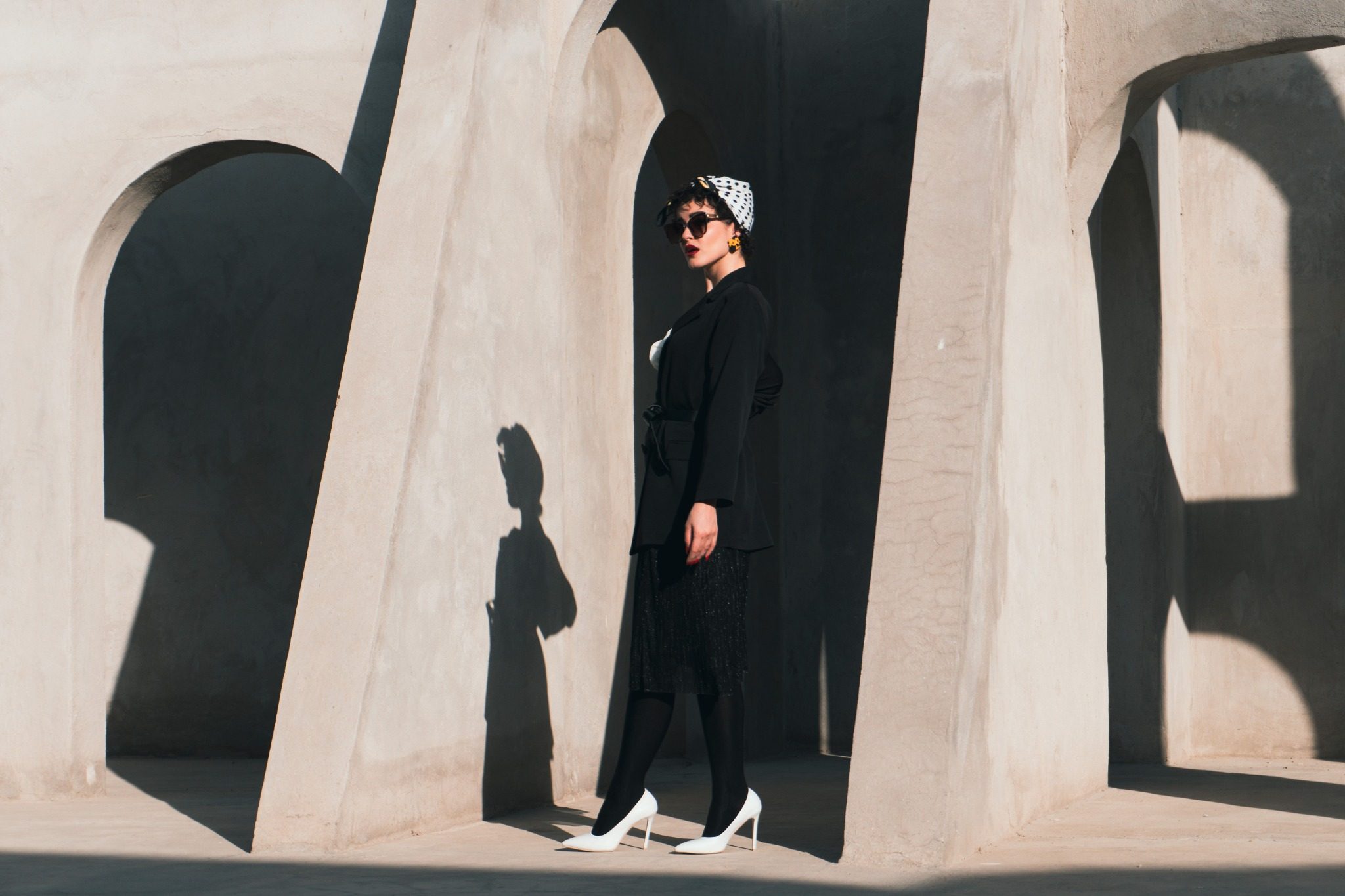 Architectural fashion campaign with strong shadows and black styling